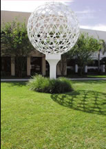 Sculpture of a large, white golf ball sitting on a tee